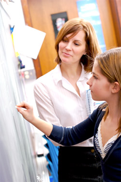 Girl Writing On Chalkbaord